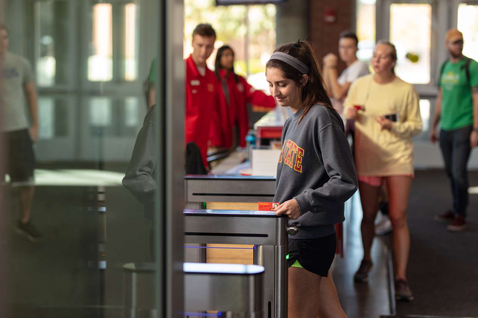 A student scans their ISU ID card to enter State Gym